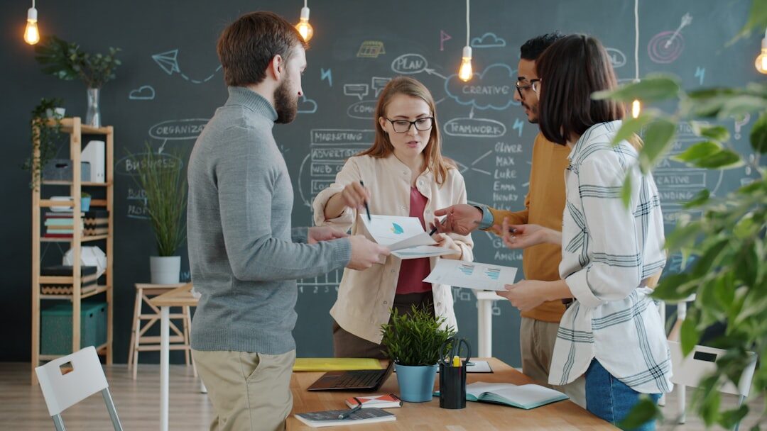 Young startup team collaborating around a whiteboard in a modern office
