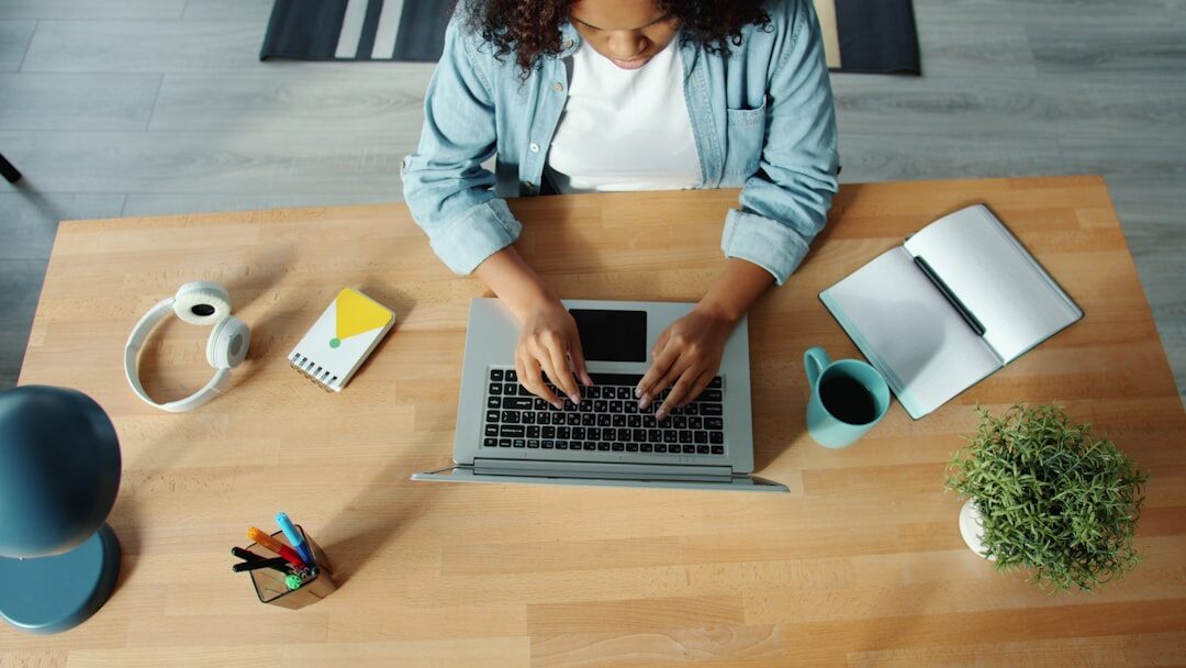Person working on laptop in a bright modern workspace
