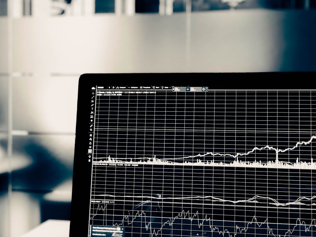 Data analytics dashboard on screen with charts and graphs
