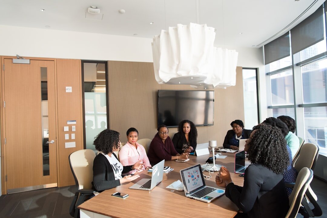 Modern tech conference room with large screens and people collaborating
